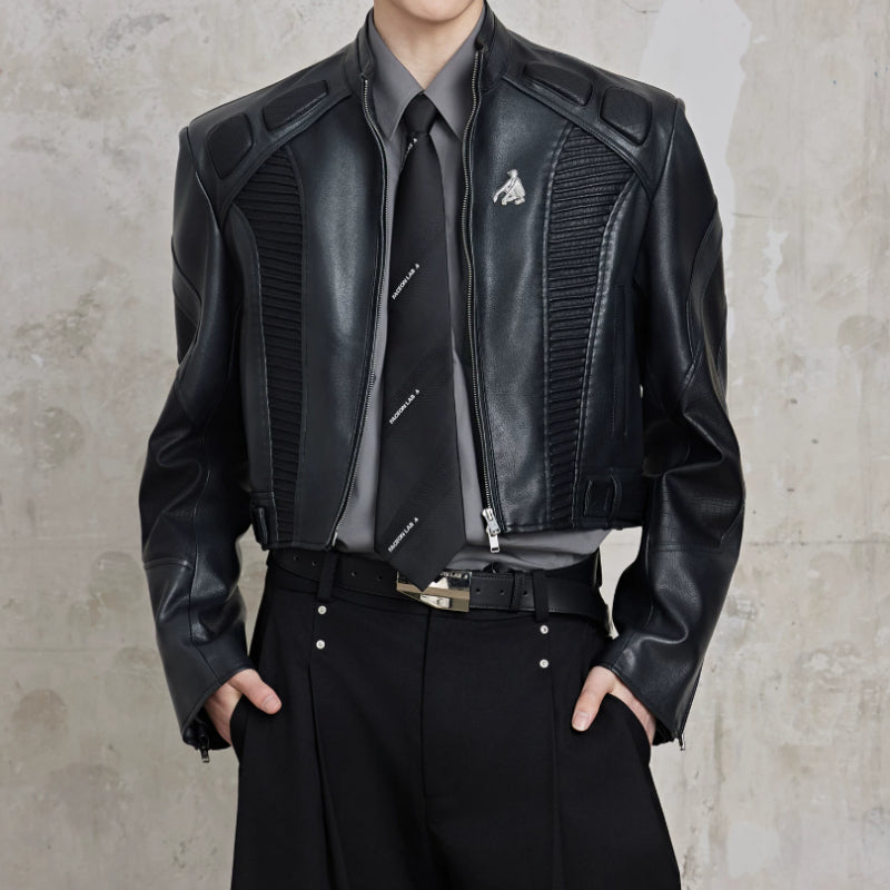 Black short biker leather jacket with quilted panels, zip front, snap cuffs.