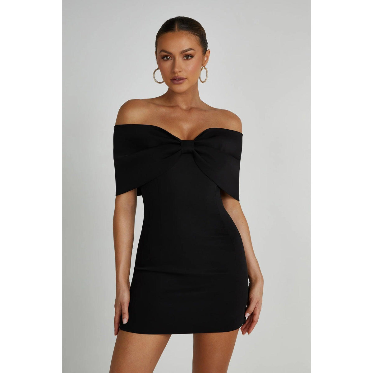 Black off-shoulder mini dress with front bow at bust and short sleeve coverage