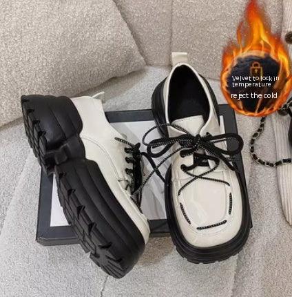 Cream lace-up sneakers with black laces and chunky platform sole
