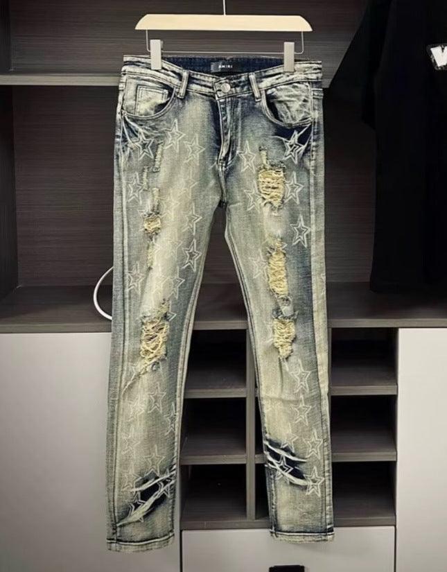 Men's slim ripped jeans with star graphics and textured distressed patches