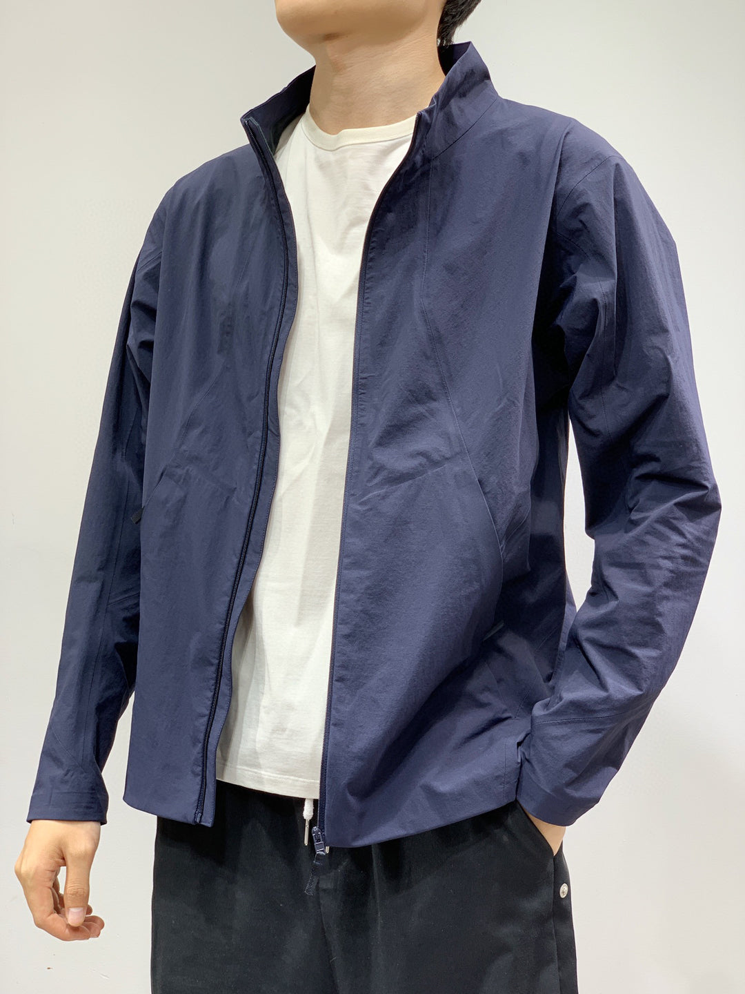 Men's navy stand-collar full-zip jacket with long sleeves, front zip and pockets