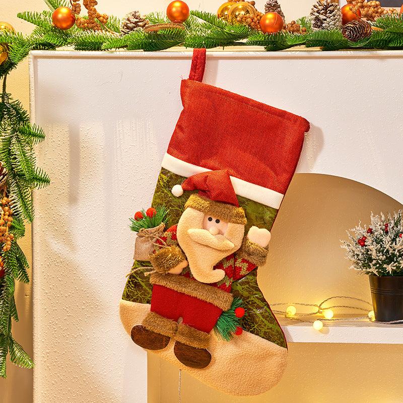 Hanging Christmas stocking with cartoon nutcracker figure, red top cuff and holiday garland