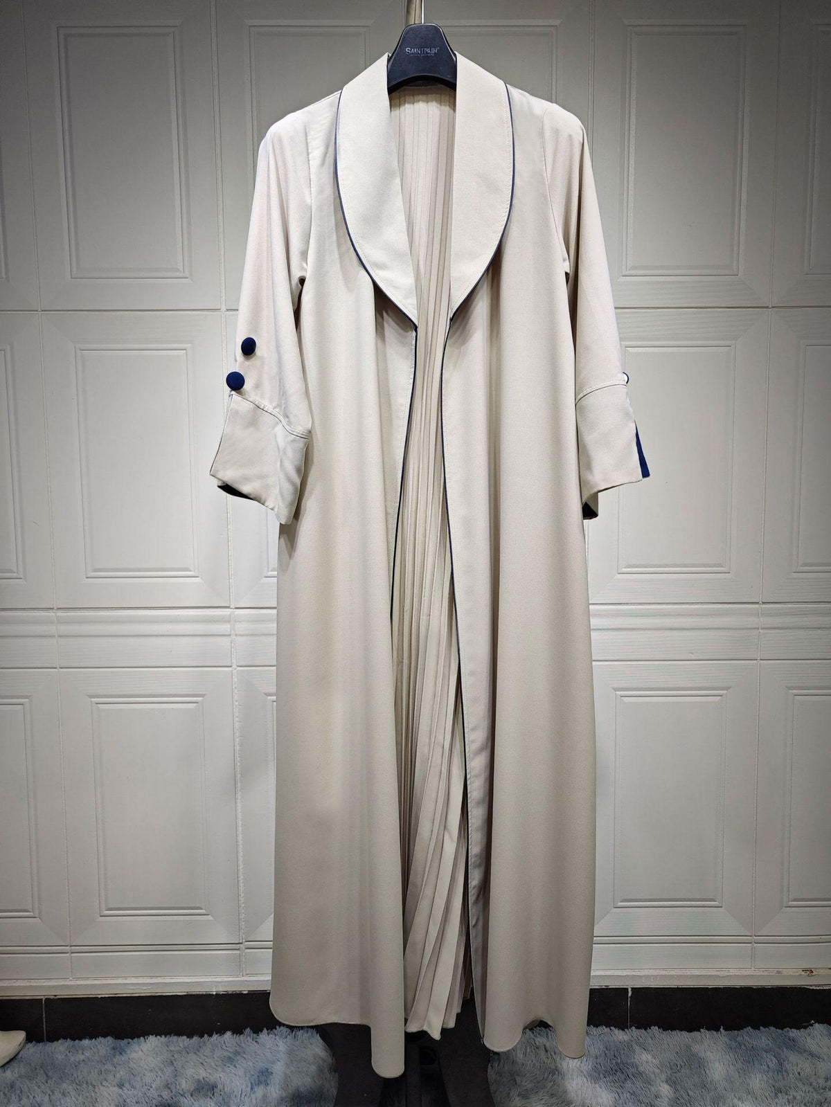 Long cardigan dress in cream/ivory with open front V lapel and three-quarter sleeves.