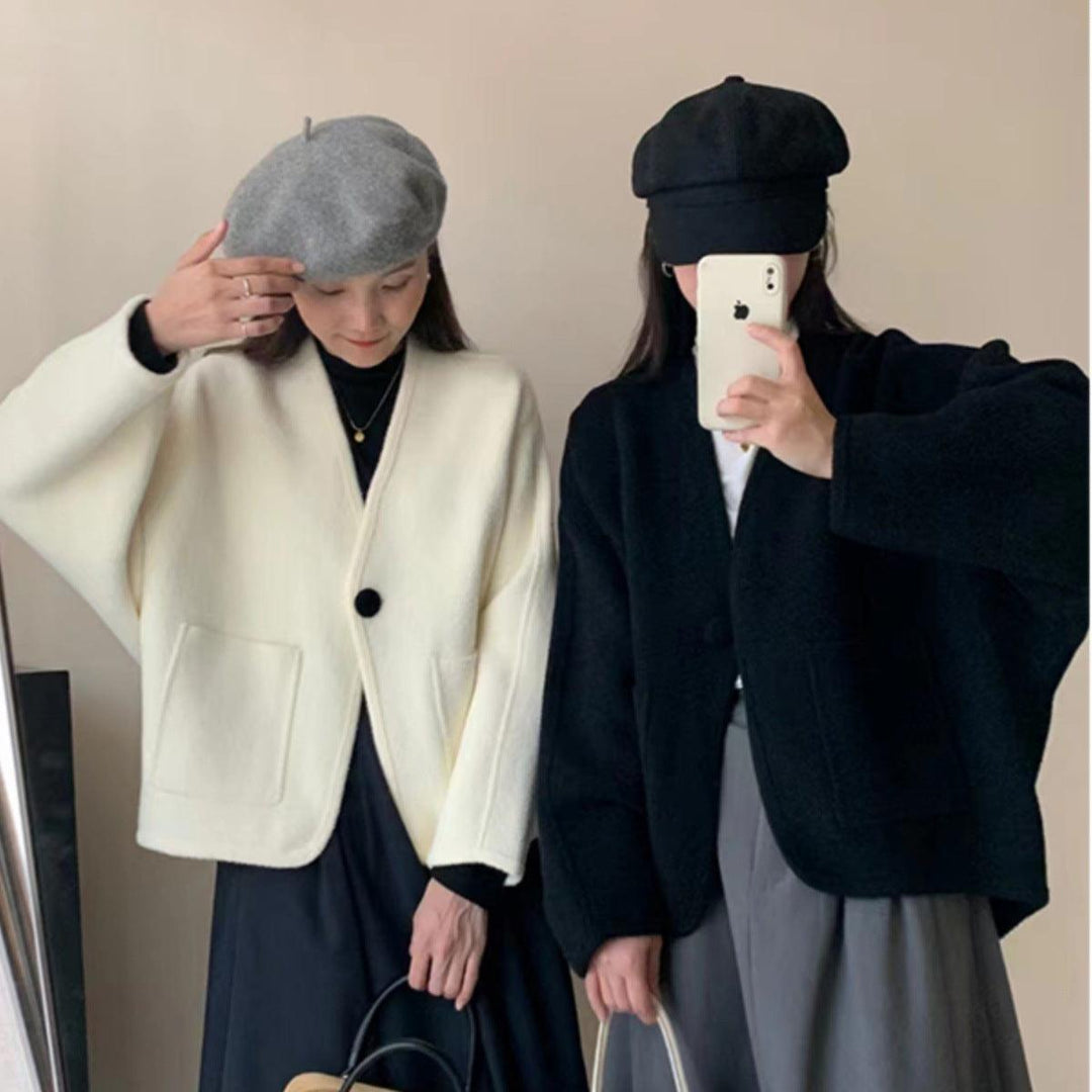 White button-front wool coat with round neckline and front patch pockets