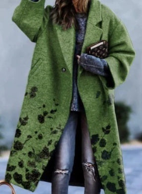 Green long-sleeve wool coat with front buttons and dark pattern on lower front