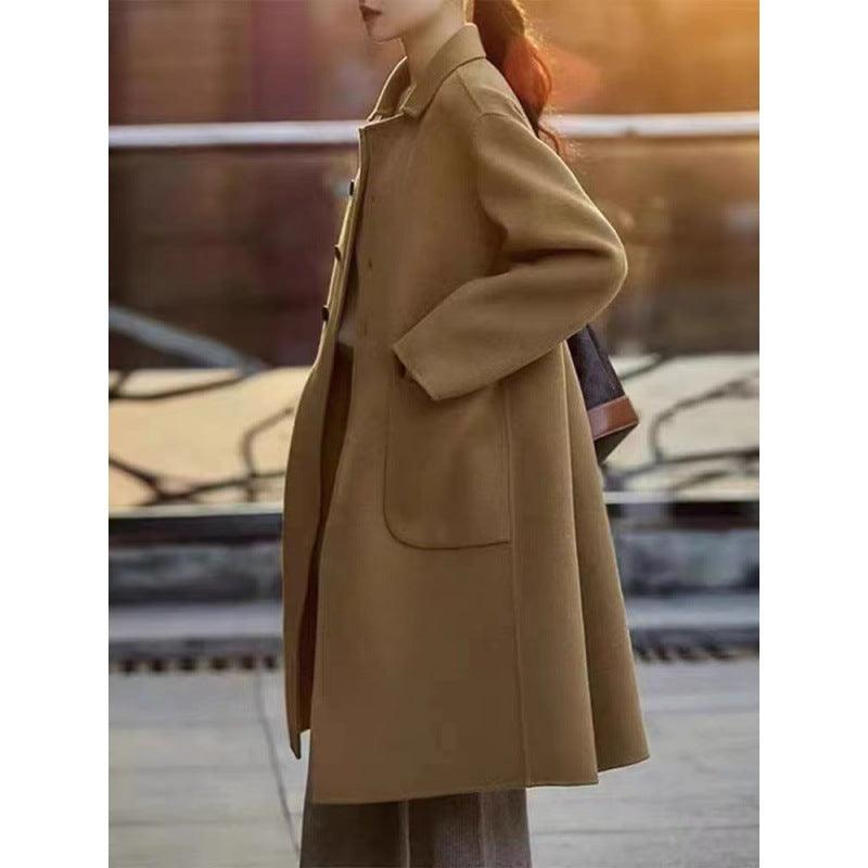 Women’s mid-length winter coat, camel, button-front with wide lapel and flap pockets