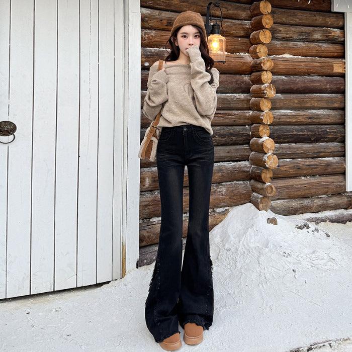 Women's black fringed skinny jeans with wide flared legs and frayed cuff hem