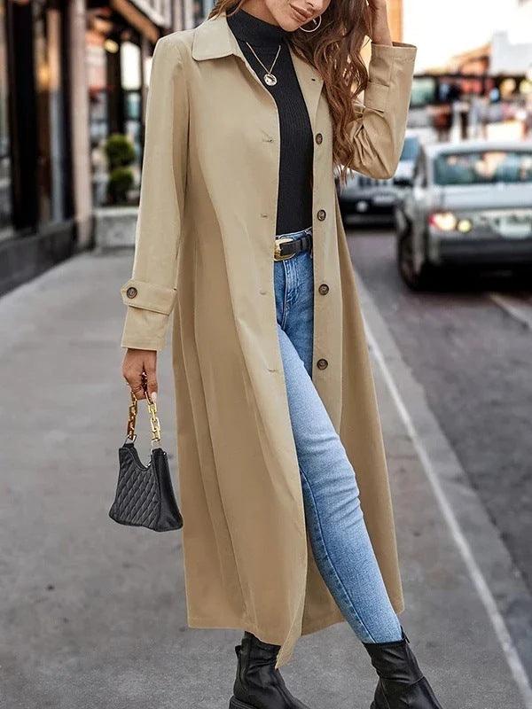 Women’s long apricot trench coat, button-front placket, notched lapels, long sleeves.