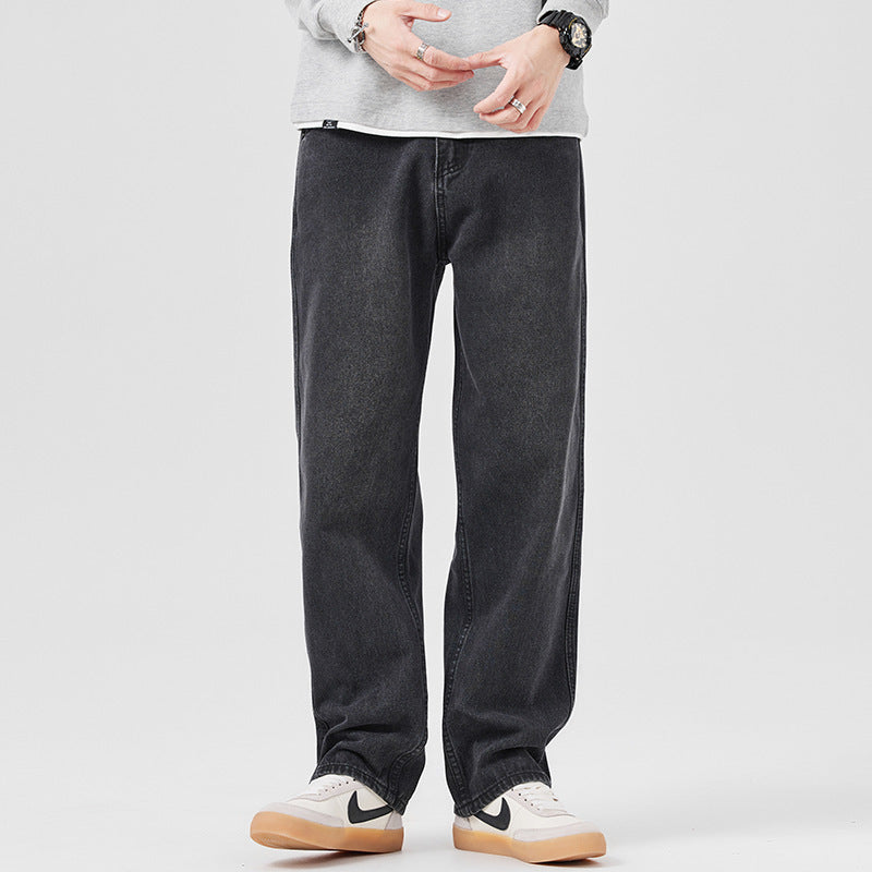 Loose-fit men's black jeans with straight-leg silhouette and visible pocket seams.
