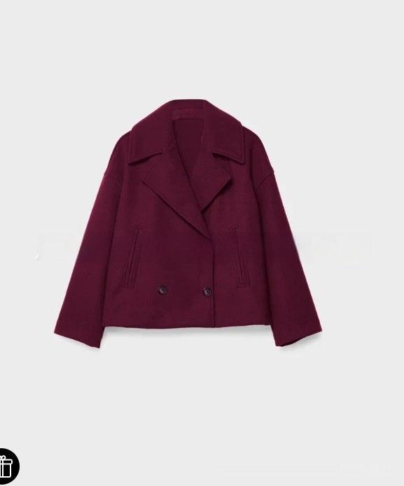 Amaranth long-sleeve coat with structured shoulders, notched lapels, and button front.