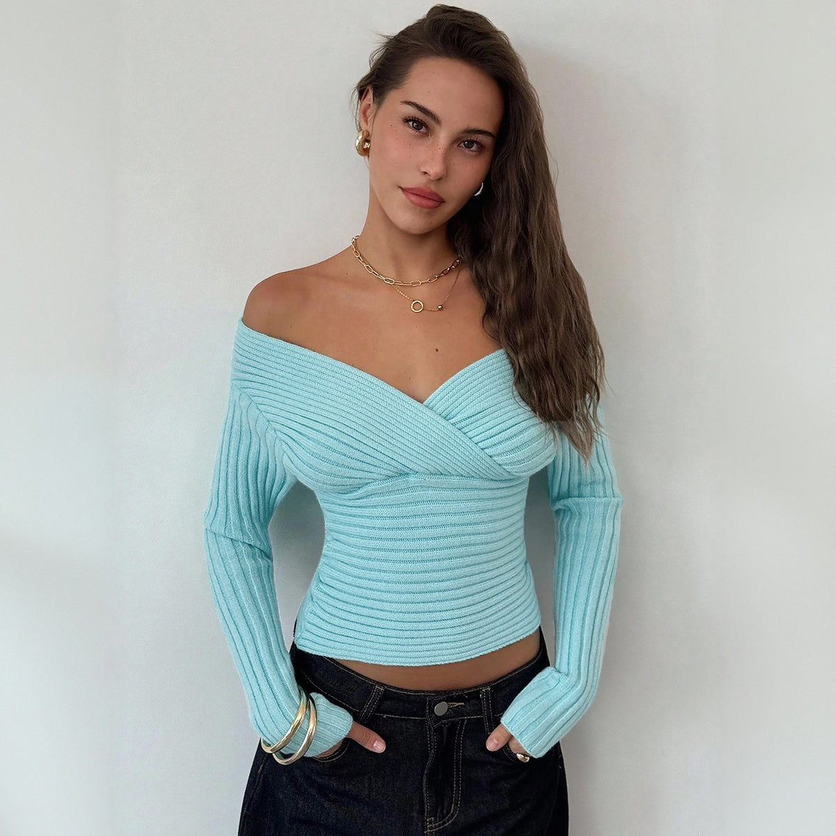Light blue ribbed knit long-sleeve V-neck wrap top with draped neckline