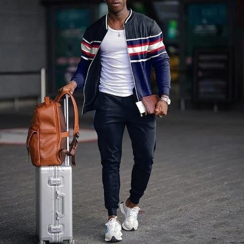 Navy two-piece set with striped track jacket, white T-shirt, and dark jogger pants