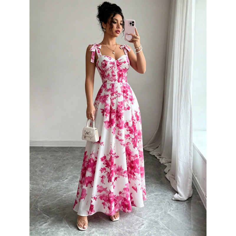 Pink floral maxi dress on white with tied spaghetti straps, fitted bodice and full skirt