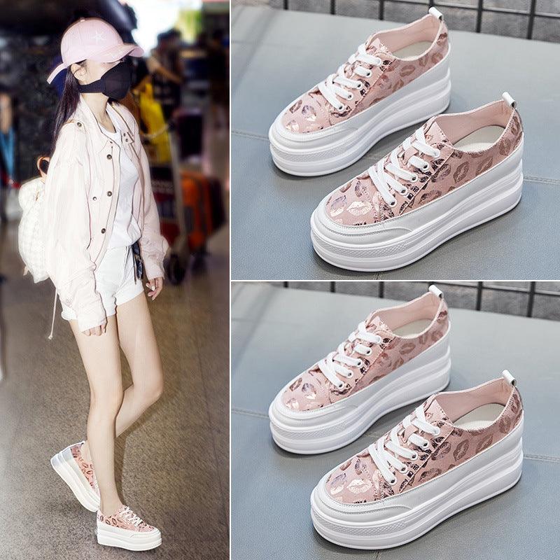 Pink platform sneakers with thick white soles and leopard print panels