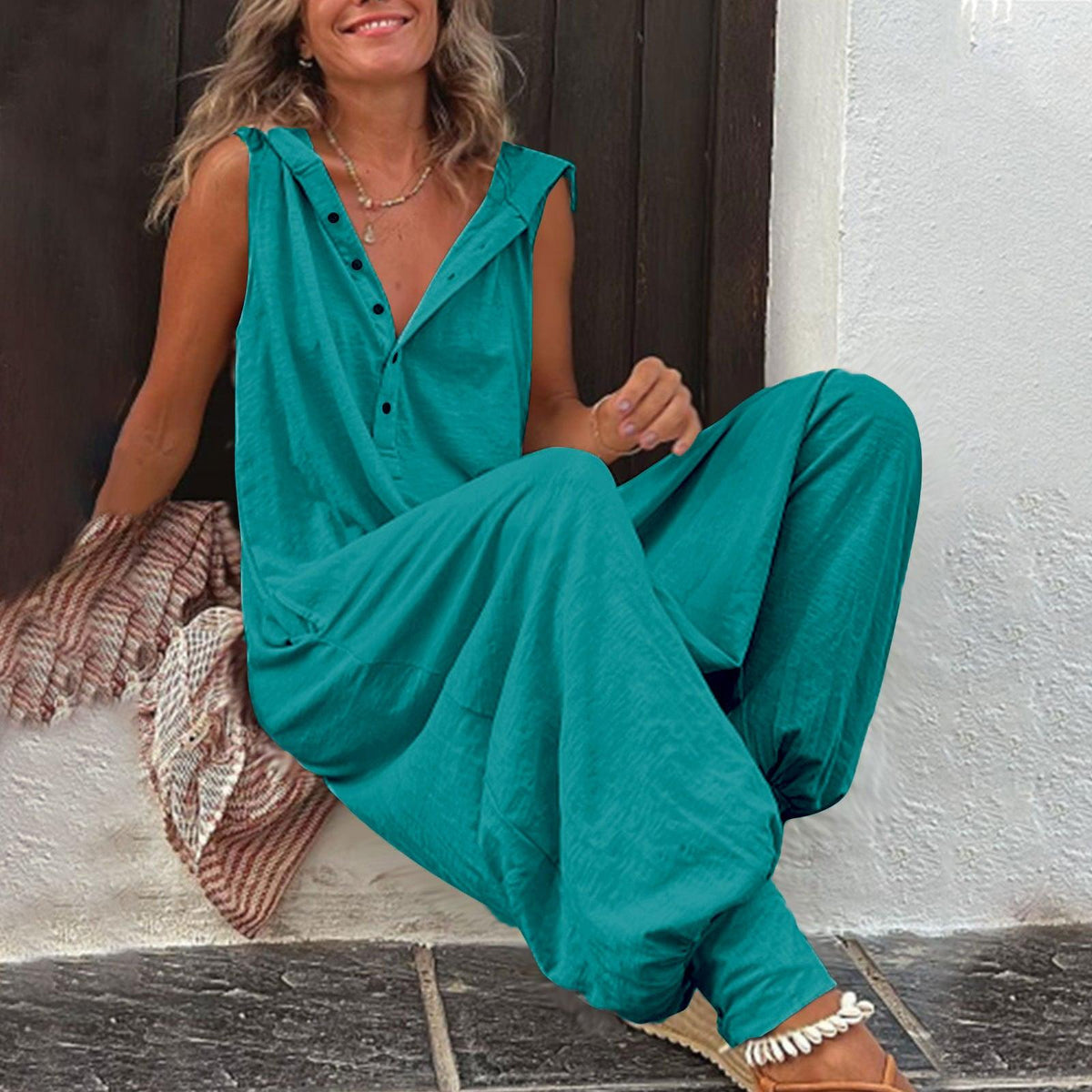 Teal sleeveless hooded jumpsuit with button-front placket and wide-leg pants