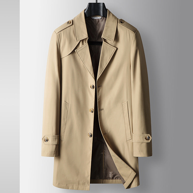 Beige youth trench coat with button front, notched lapels, epaulettes, and flap pockets