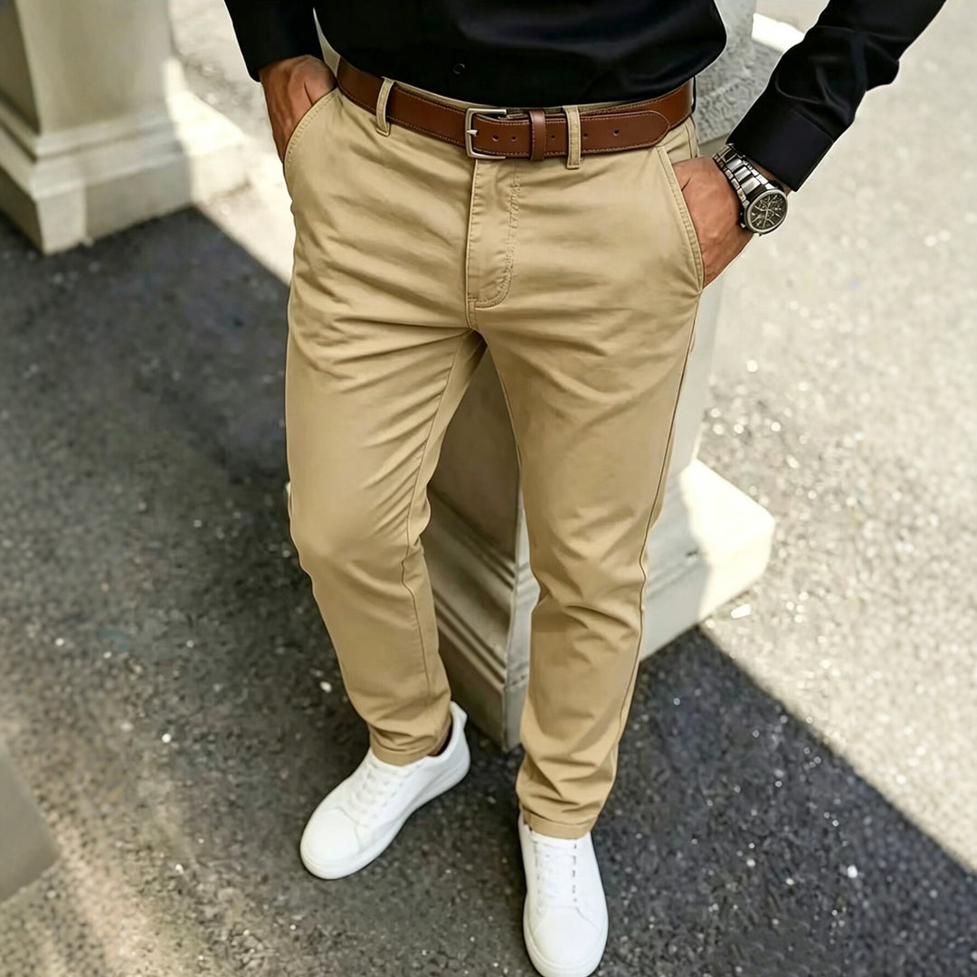 Khaki slim-fit casual cotton pants with belt loops and tapered legs.