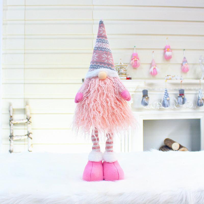 Pink Christmas gnome doll with striped knit hat and fluffy beard, pink pants