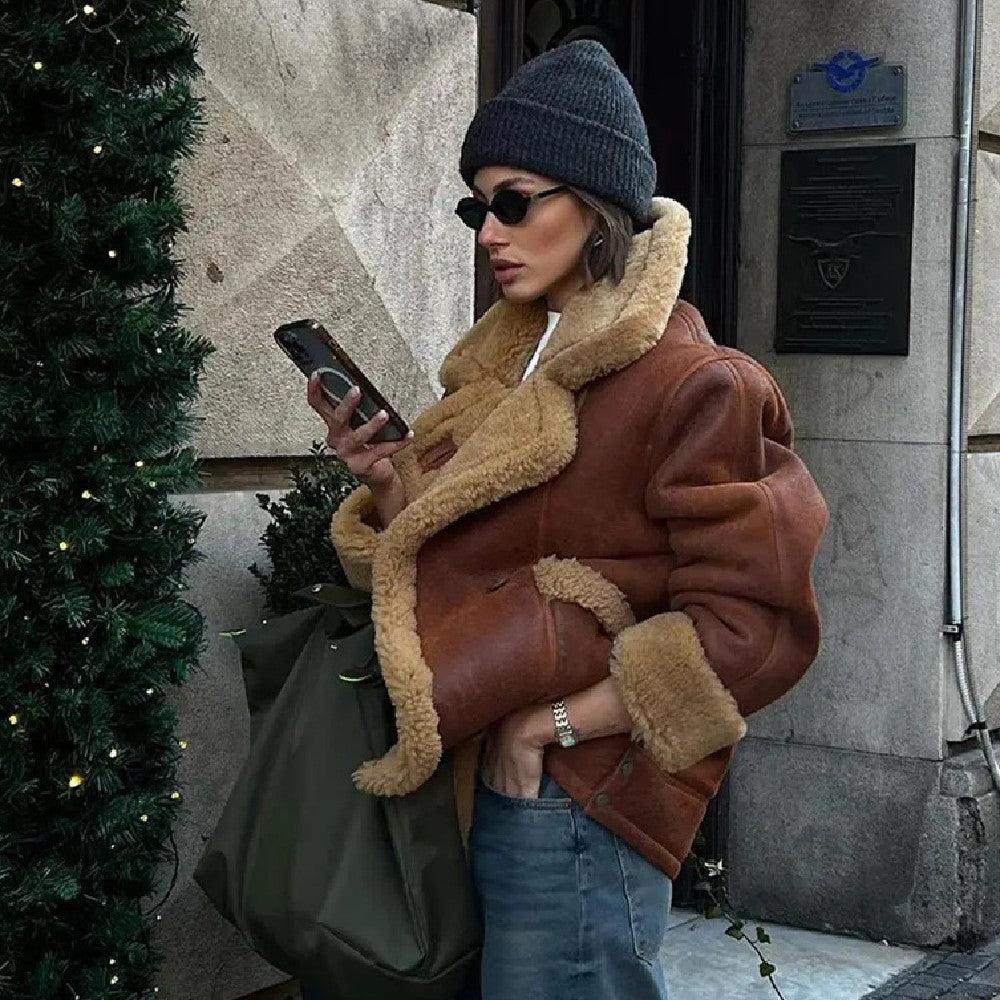 Dark brown lamb-wool shearling coat with long sleeves, button front, and side pockets