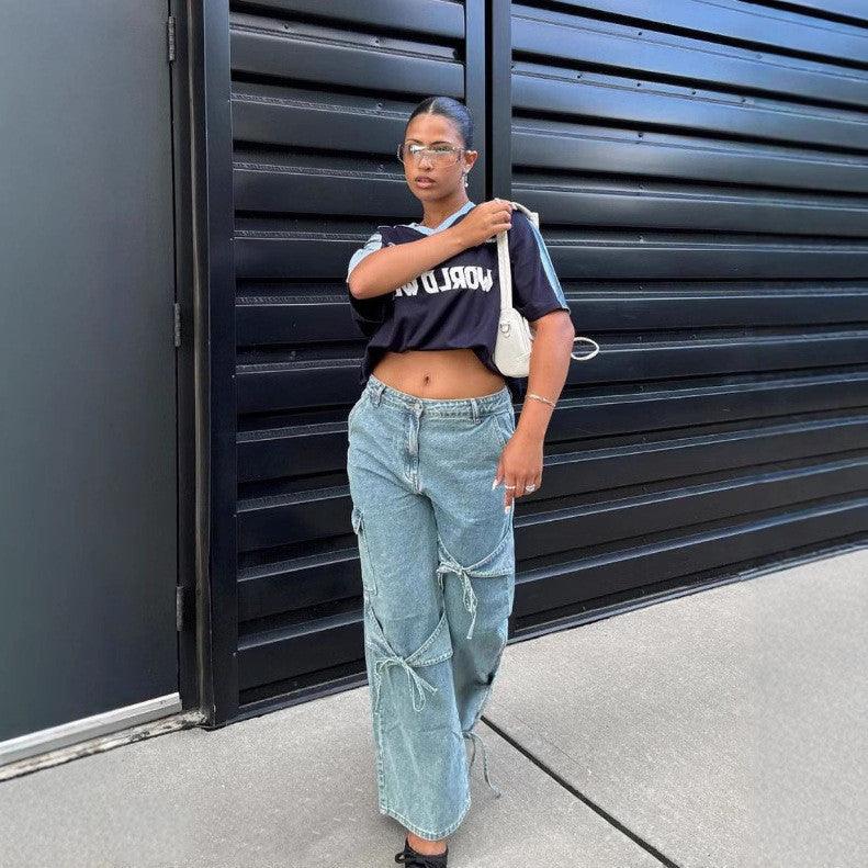 Light blue wide-leg denim pants with cargo-style panels and drawstring ties