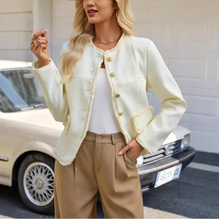 Beige short jacket top with gold button front, flap pockets, and fuzzy trim