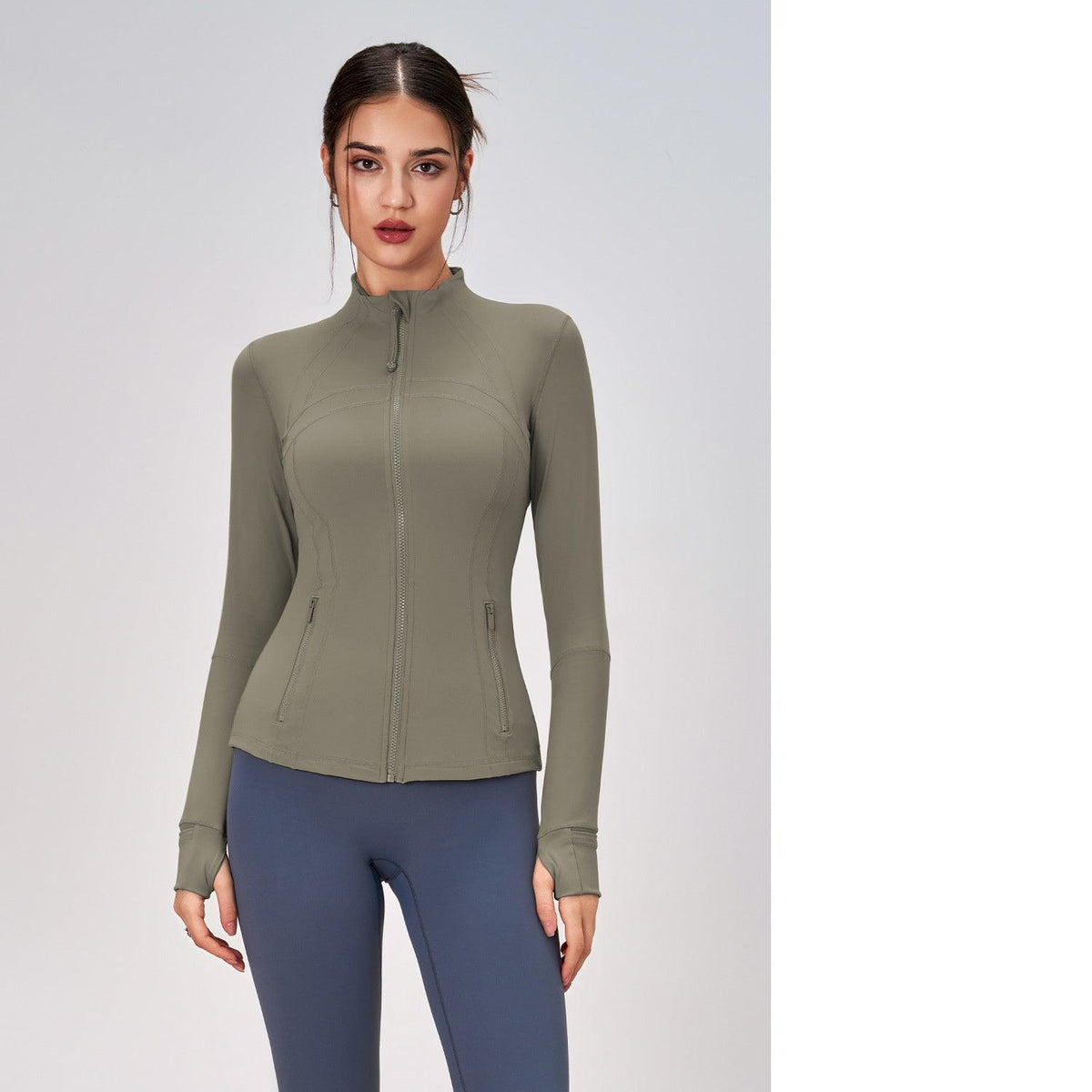 Women's olive green zip-up yoga coat with high neck, long sleeves, and zip hand pockets