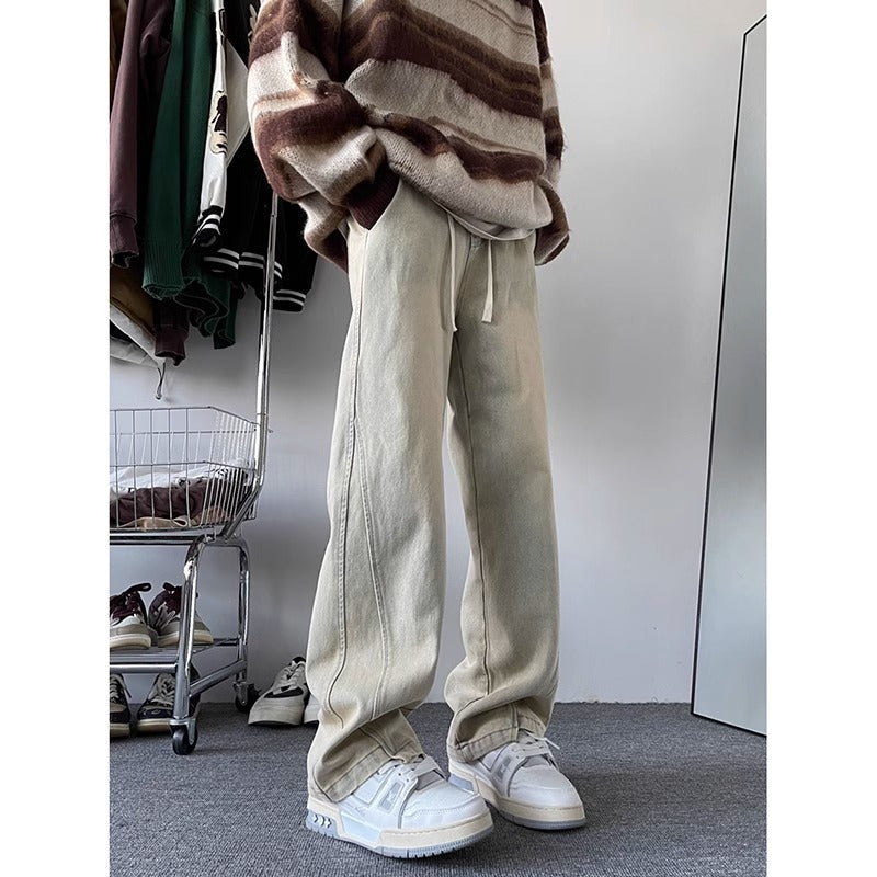 Men's pale denim wide-leg trousers with drawstring waist and cuffed hem