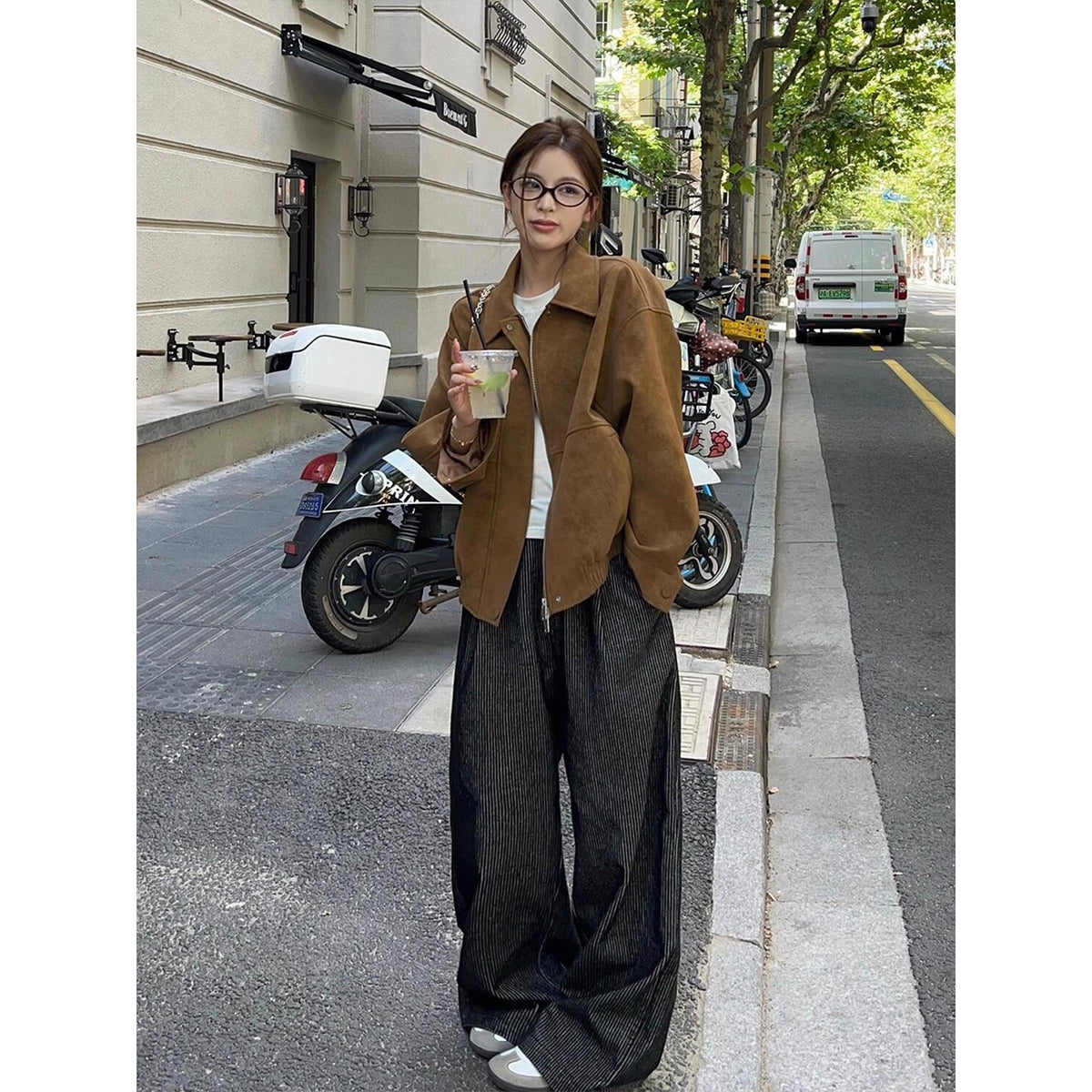 Brown stand-collar loose jacket with zip-front, styled with dark wide-leg pants