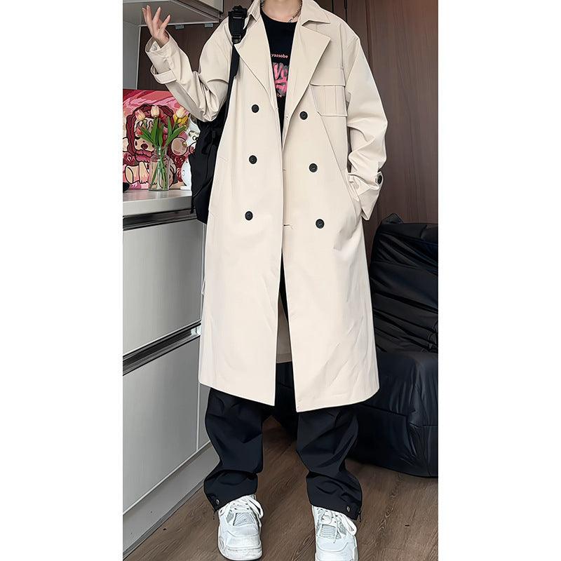 Off-white long trench-style coat with wide lapels, double-breasted buttons, and flap pockets.