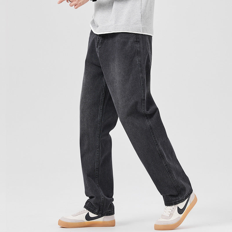 Loose-fit men's black jeans with relaxed straight legs, belt loops, and stitched seams.
