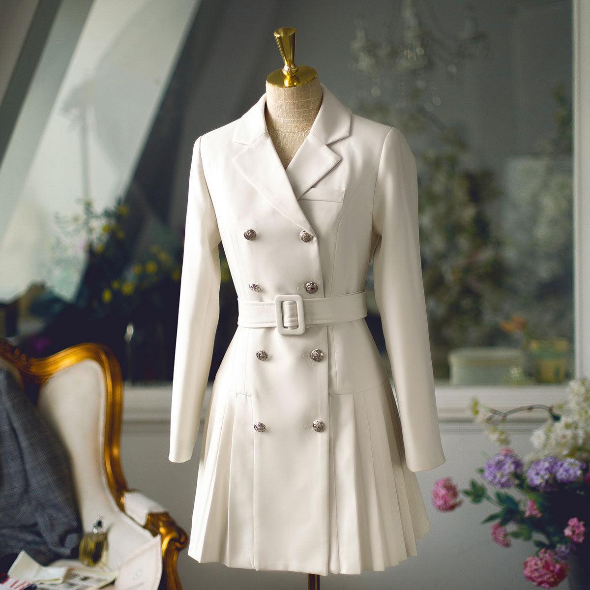 Beige double-breasted blazer with lapels and belted waist, pleated mini skirt hem