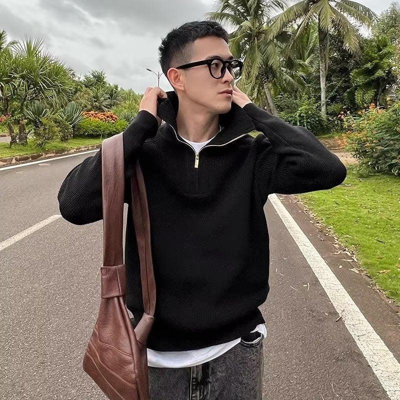 Black quarter-zip knit pullover with long sleeves and ribbed trim