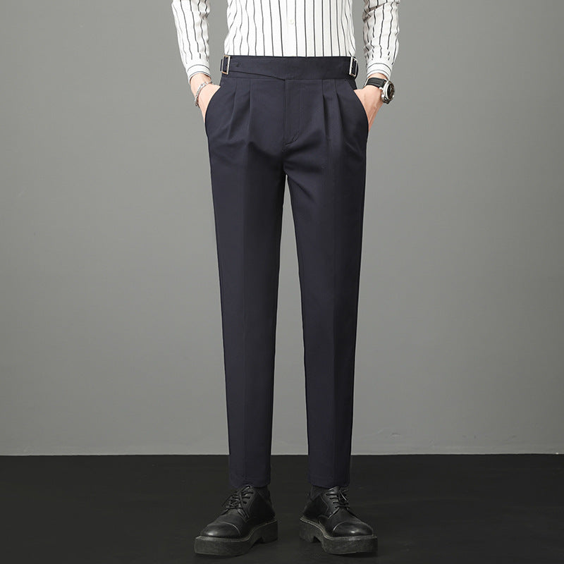 Slim-fit young men’s suit trousers in navy blue, flat front, belt loops, tapered fit.