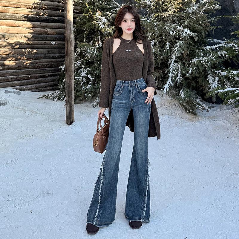 Women's blue fringed skinny jeans with wide flared legs and raw hem