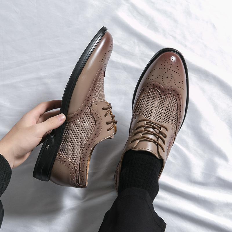 Beige leather lace-up business shoes with perforated panels and brogue-style toe