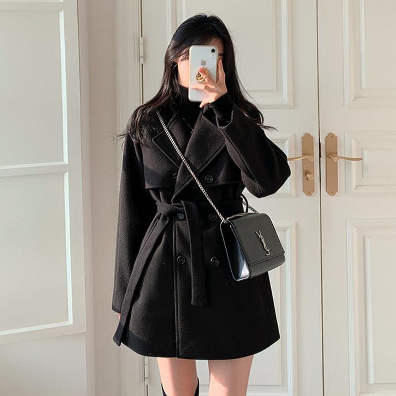 Black wool coat with loose collar, button front, belted tie and lace-up detailing