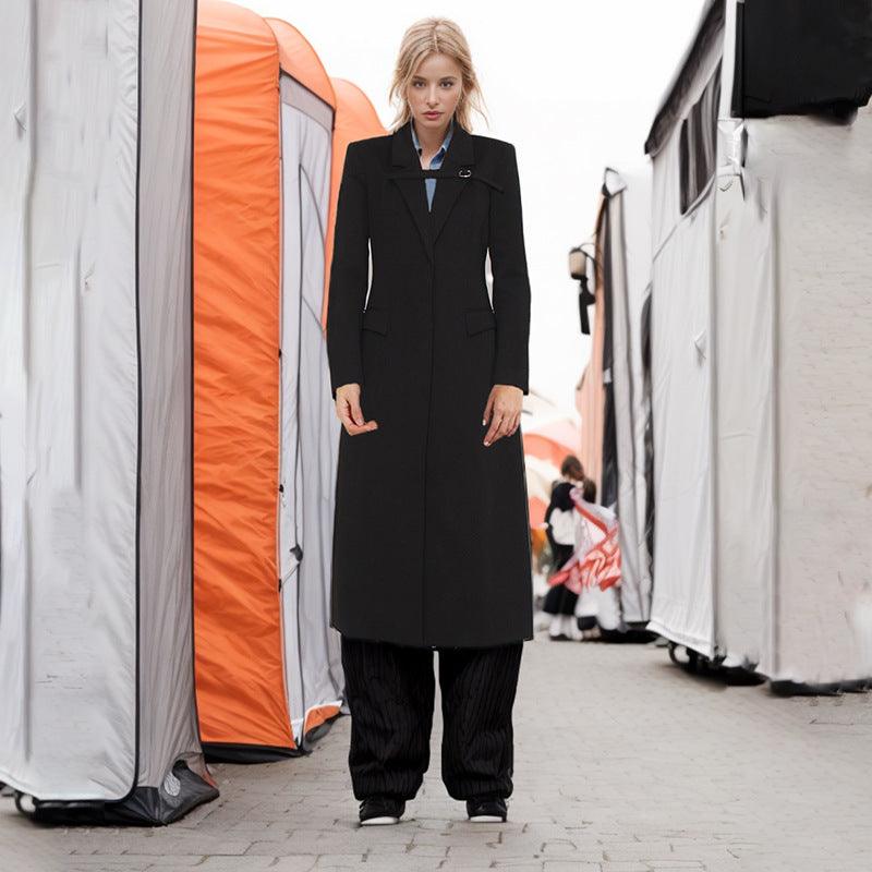 Women's black long coat with lapel collar, front buttons, and side flap pockets