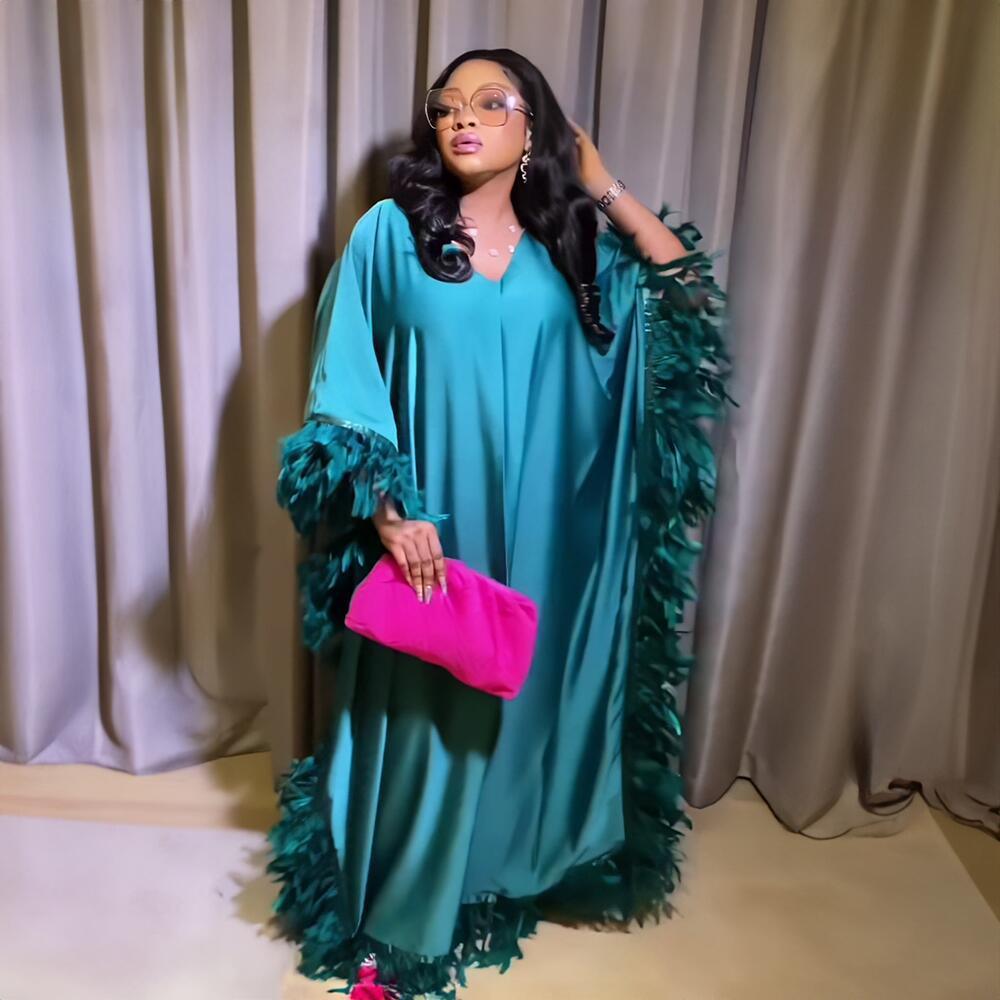 Teal loose maxi dress with feather-trimmed sleeves and layered fringe hem