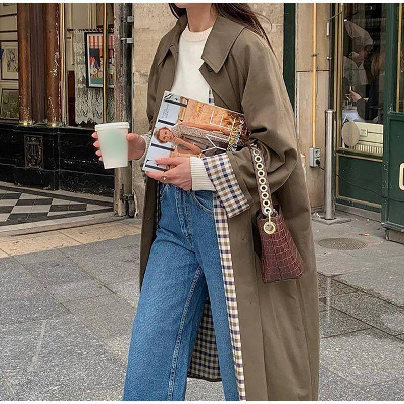 Khaki green long button trench coat with notch collar and belted silhouette