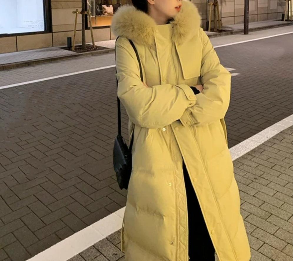Mid-length down jacket in yellow with faux-fur hood, long sleeves, button front, belt