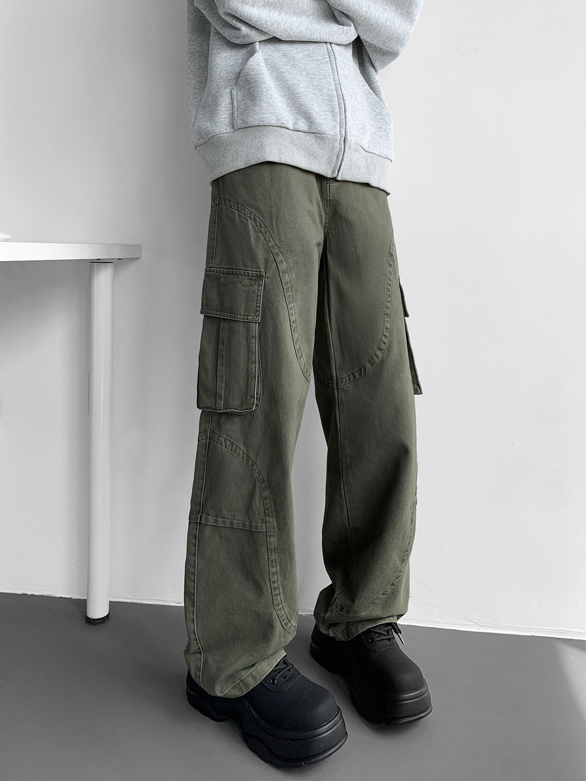 Army green wide-leg cargo pants with thigh cargo pocket and layered side panel