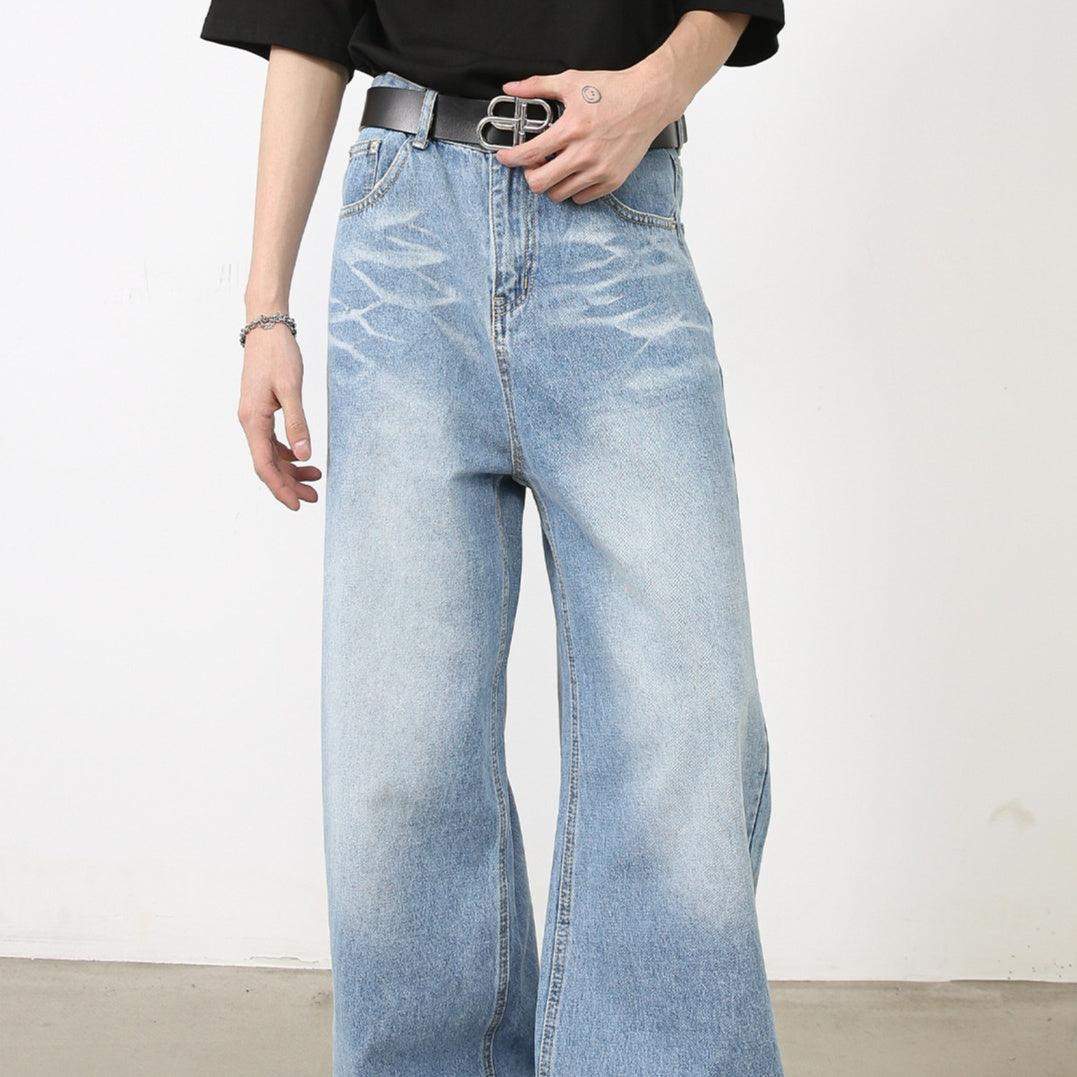 Light blue denim pants with wide legs, belt loops, and metal button closure