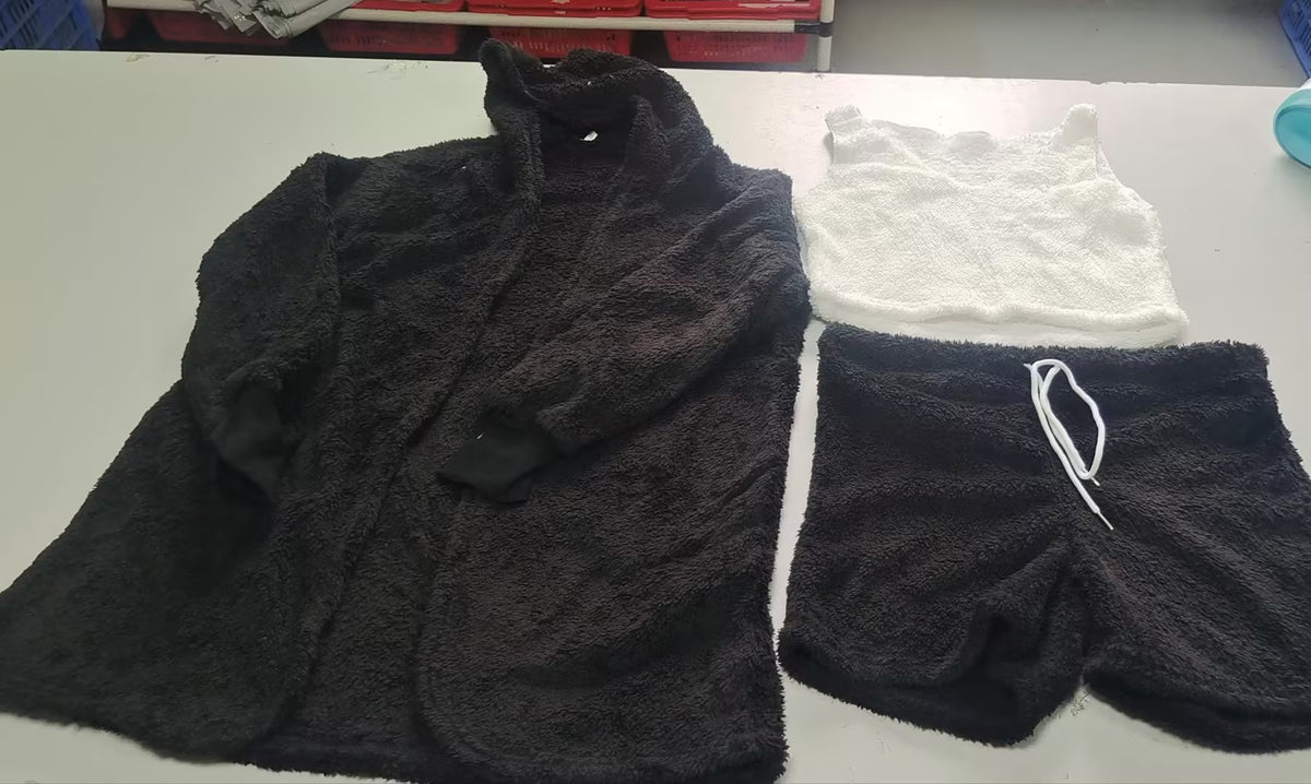 Women's velvet pajama set in black: crop top, drawstring shorts, matching robe.