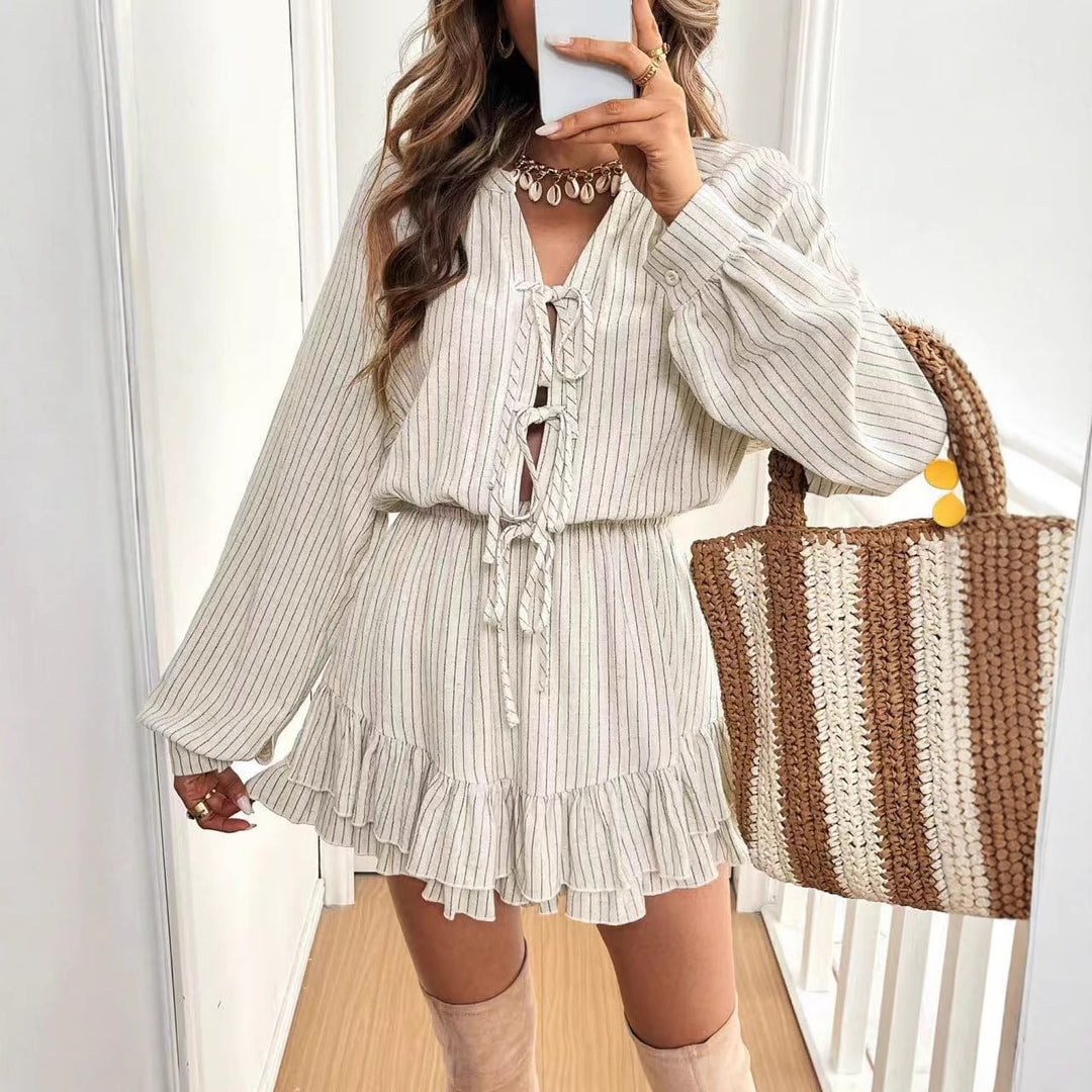 White cotton-linen dress with round neck, lace-up front, lantern sleeves, and tiered hem
