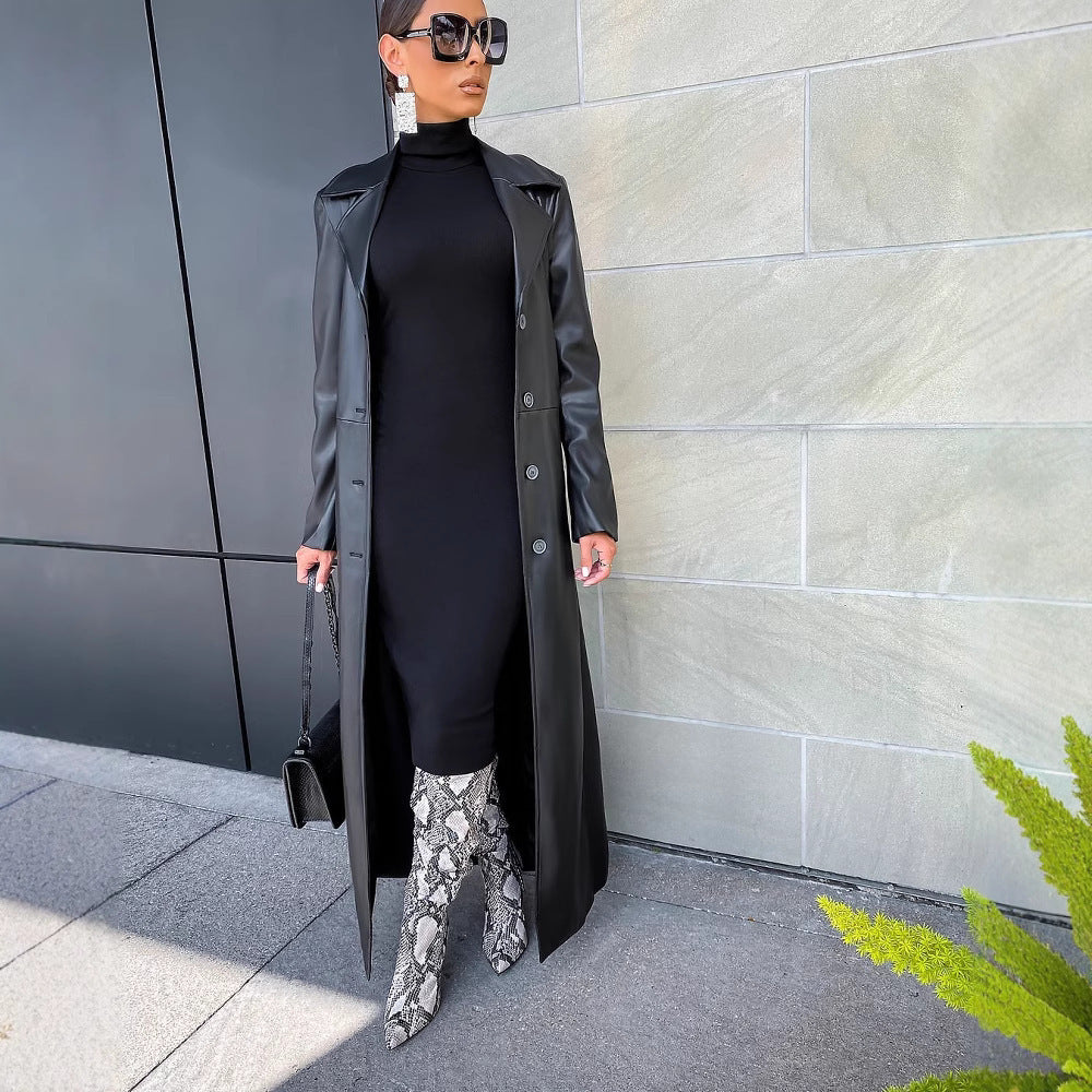 Long black leather coat with lapels and button front, belted waist, side slit hem