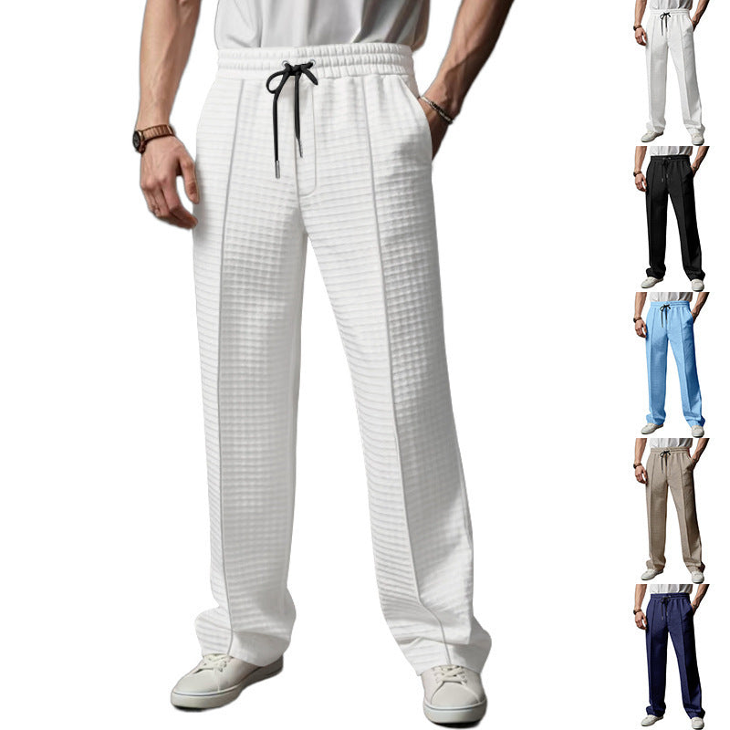 White jogger trousers with elastic waistband and black drawstring, check texture.