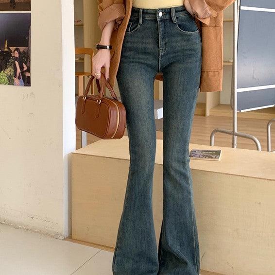 Dark blue low-waist flared skinny jeans with belt loops, button closure, and zip fly