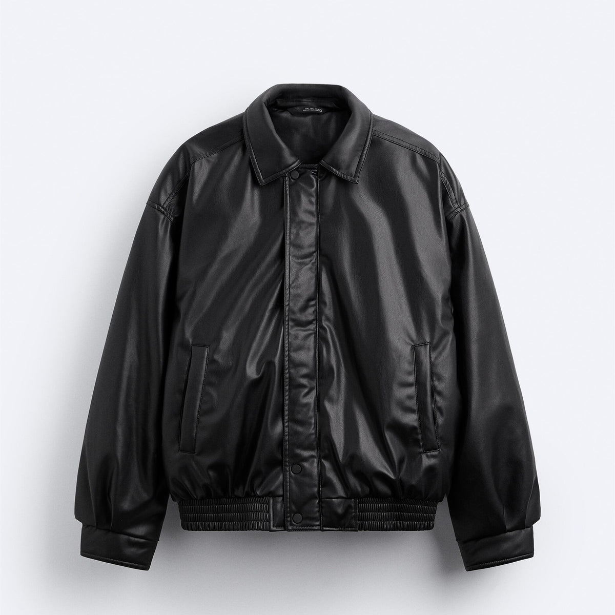 Black faux leather jacket with snap placket, stand collar, and ribbed hem