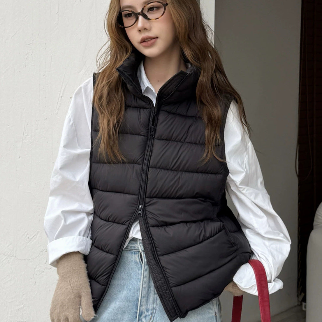 Women's dark padded sleeveless vest with faux-fur hood trim and front zipper