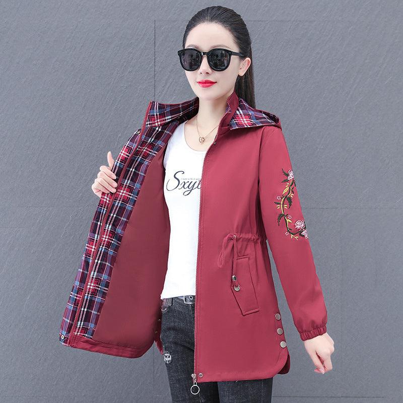 Women's hooded mid-length trench coat in cameo red with plaid hood lining and floral sleeves